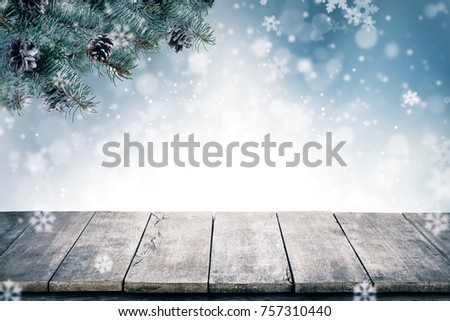 Christmas background with spruce branches and cones with snow flakes and copyspace for text. Abstract holiday concept with empty vintage planks. High resolution image