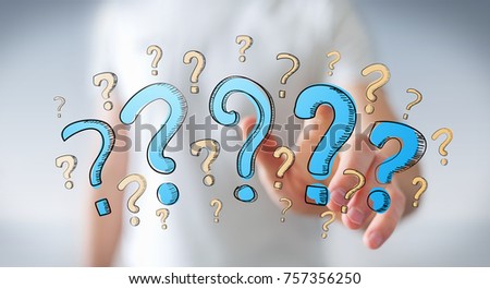 Businessman on blurred background holding hand drawn question marks in his hand