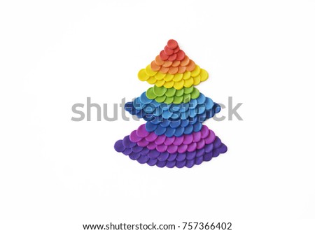Christmas tree fashioned from plasticine. Colors of rainbow. Christmas tree handmade. White background.