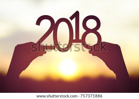 Silhouette 2018 in hand. Background sunrise Royalty-Free Stock Photo #757371886
