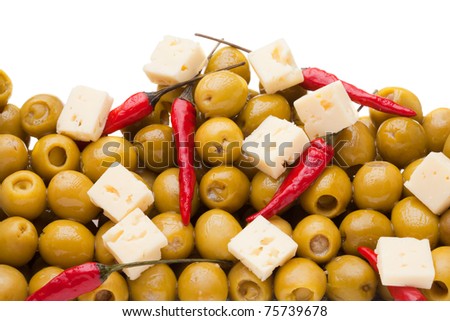 Pile of olives and chili pepper and sheep cheese on white background