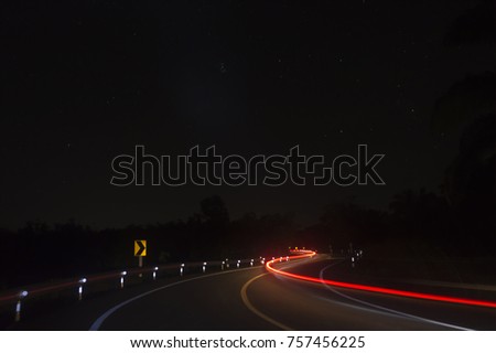 Blurry night scene on the country road at Thailand.