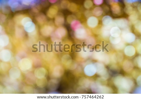 Blurry golden, yellow, red and blue Christmas light or bokeh background.