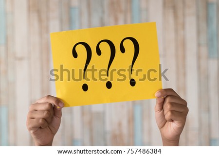 hand holding a paper note with question mark.question mark written on paper Royalty-Free Stock Photo #757486384