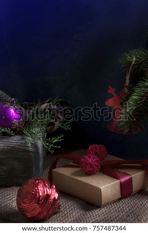 Christmas gift under a xmas tree with candy and decoration items and red deer