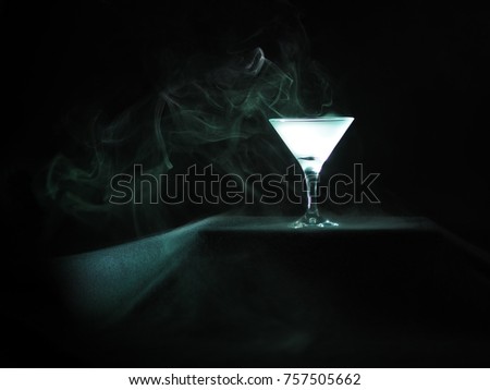 martini glass with magical light effect and vapor