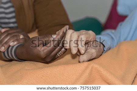 Hand of nurse holding a senior woman. Concept of helping hands, care for the elderly.