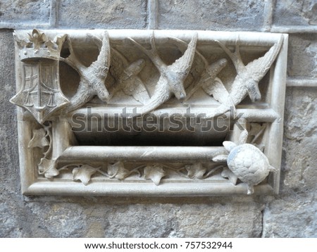Medieval architecture ornaments (birds and a turtle) on a gothic building in the old town of Barcelona, Catalonia, Spain