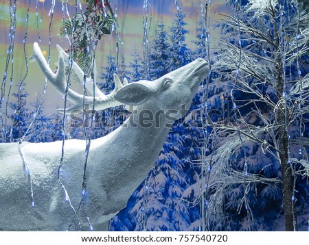 Background. New Year's holiday decoration of the winter snow-covered forest. Deer.