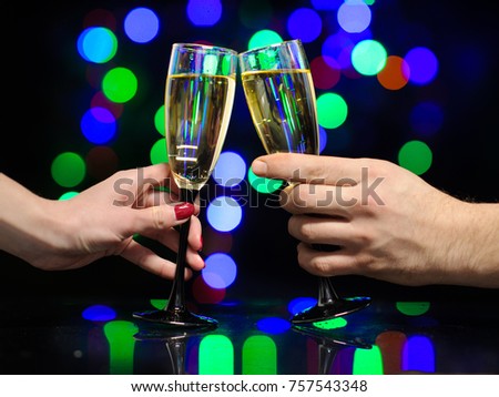 Man and woman hands with full champagne glasses. Cheers