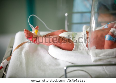 Premature little baby in an incubator at the neonatal section of the maternity Royalty-Free Stock Photo #757545823