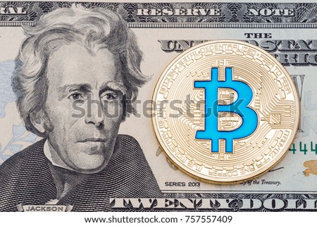 Golden cryptocurrency blue bitcoin on twenty dollar banknote background. High resolution photo.