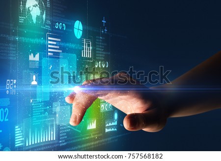 Female finger touching a beam of light surrounded by blue and green data and charts