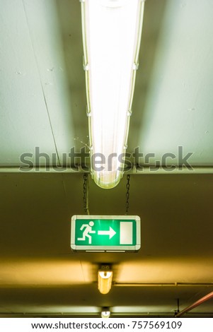 Illuminated sign on the ceiling shows the emergency exit