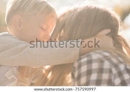 mother kissing her little son