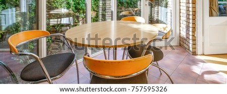 Table and chairs in a patio, cover banner