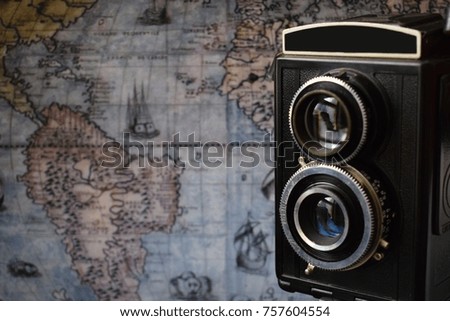 retro camera with the old world map in the background