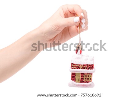Christmas decoration snow-covered house on a tree in hand on white background isolation