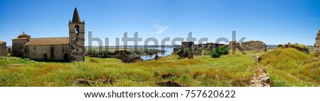 Wide panorama of the interior of Juromenha fortress (or castle) showing the abandoned, but still standing church, and all other falen ruins above the Guadiana River. Alentejo, Portugal.