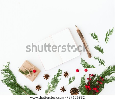Christmas composition. Flat lay with decorations and notebook. Wish list or goals concept