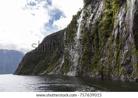 Natural wonder of milford sounds and waterfalls around fiords