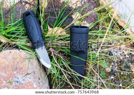 A versatile Scandinavian knife. Knife for everyday work. A photo on a background of nature.