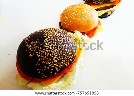 White cheeseburger and black cheeseburger.
