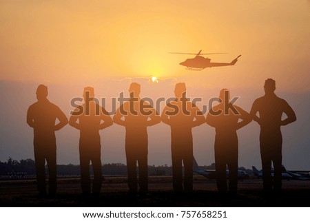 Silhouette of pilot standing on landing field