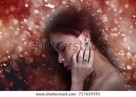 Red Brunette Shinny Hair Style on Asian Make Up Woman, Portrait half body with jewelry diamond emerald earring ring, studio spot lighting gray background