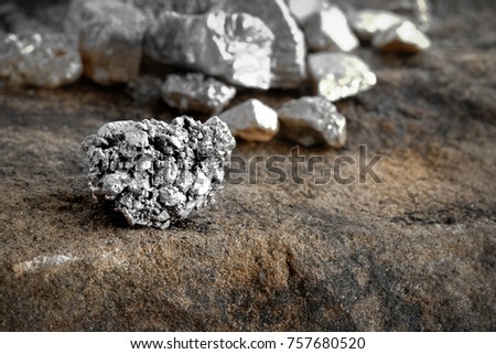 lump of silver or platinum on a stone floor Royalty-Free Stock Photo #757680520