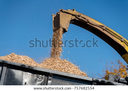 An industrial wood chipper at work Royalty-Free Stock Photo #757682554