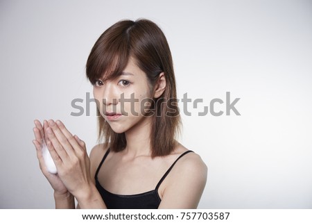 Asian girl use facial foam. Young short hair Asian girl on white background.
