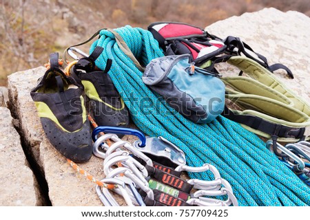 Climbing equipment - bag for magnesia rope and carbines view from the side close-up. A rocks and mountains on background. Concept of outdoor sport