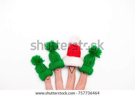 happy family with fingers in warm hats santa and elf on white background