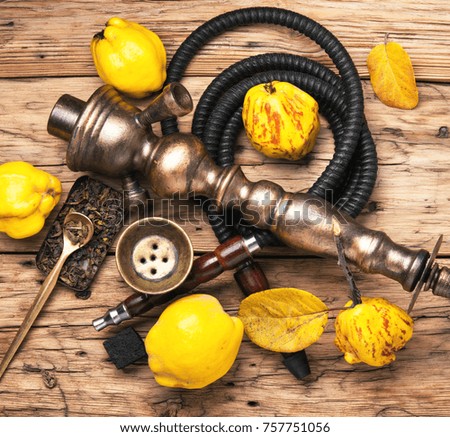 Smoking smoking hookah in Arabic style with the tobacco aroma of ripe quince