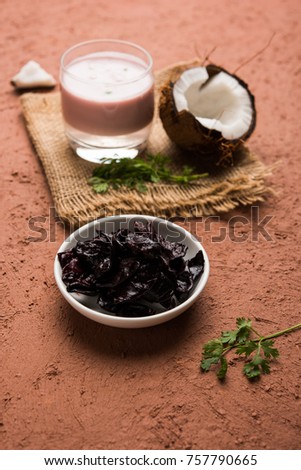 Solkadhi OR Kokum curry, A famous drink from Goa or Maharashtra`s Konkan region, served in a glass over moody background, selective focus

