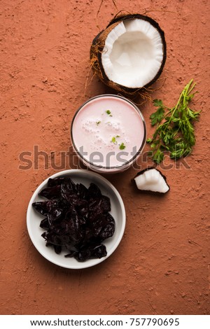 Solkadhi OR Kokum curry, A famous drink from Goa or Maharashtra`s Konkan region, served in a glass over moody background, selective focus
