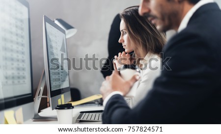 Business professionals working process at office.Young professionals work with new market project on desktop computers. Blurred background.Horizontal Royalty-Free Stock Photo #757824571
