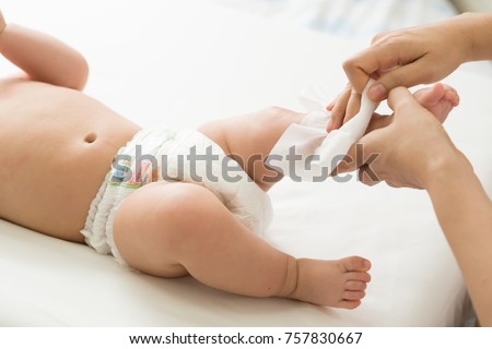 Mother cleaning up and wipes body and leg baby by wet tissue Royalty-Free Stock Photo #757830667