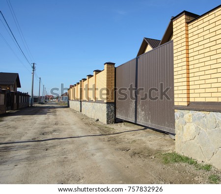 Brick and metal fence.