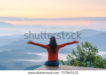 Happy traveler on mountain summit hands raised Travel Lifestyle freedom concept adventure active vacations outdoor over clouds harmony with nature