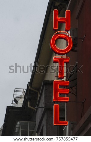 Small cheap hotel. Text Hotel on facade. Hotel in the city.