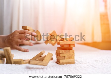 Hand of pulling wood block fail on building tower at home and drape change, choice business risking dangerous project plan failure construction,Selective block wooden Royalty-Free Stock Photo #757869322