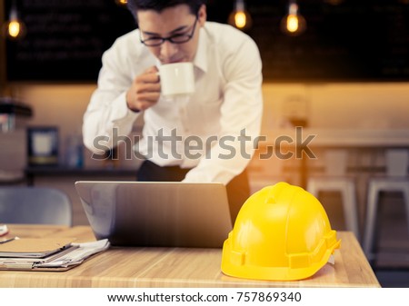 Engineer working business at office table with blueprint,paper plan,document,calculator drinking coffee break and drawing plan in laptop project 