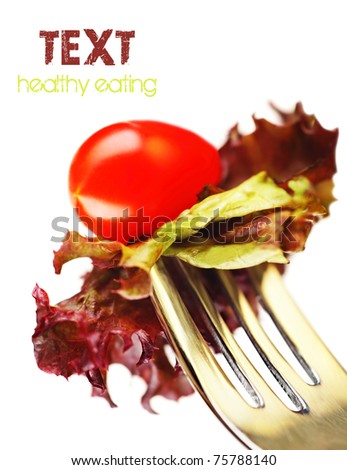 Healthy salad on  the silver fork isolated on white background, conceptual image of healthy eating & diet