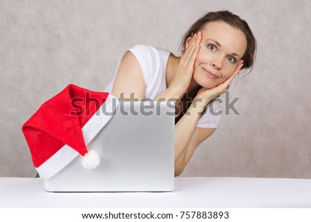 Young woman does some shopping online before christmas