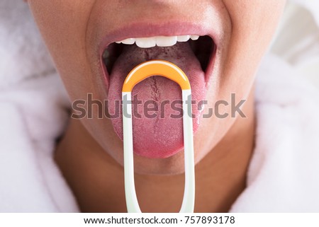 Photo Of Young Woman Cleaning Tongue With Cleaner