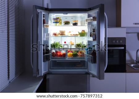 Open Refrigerator Full Of Juice And Fresh Vegetables In Kitchen Royalty-Free Stock Photo #757897312
