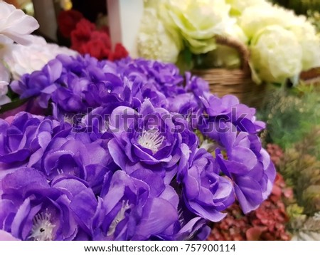 Violet hydrangeas in foreground and background with other flowers, this is a picture of artificial home-made flowers for home or interior decoration. 