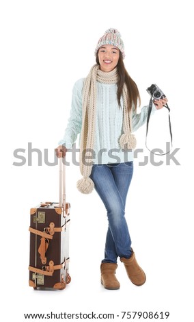 Attractive female tourist in warm clothes on white background